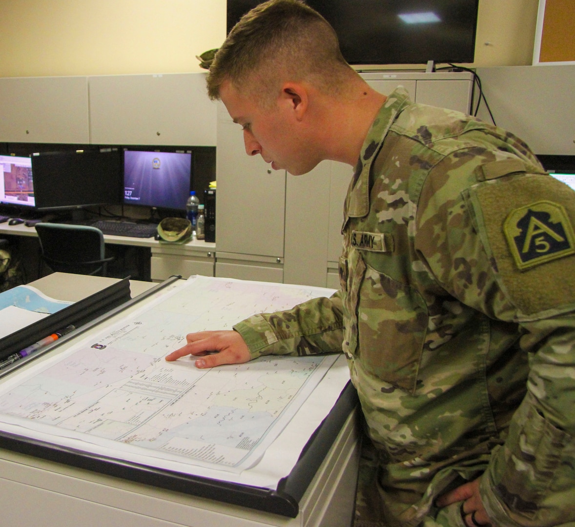 Spc. Austin T. Israel, 543rd Engineer Detachment geospatial engineer, identifies a specific point along the border from Texas to California. The detachment began their part of the border support mission by analyzing maps and refining data to paint a picture of the operating areas for commanders and decision-makers to better visualize their areas of operations.