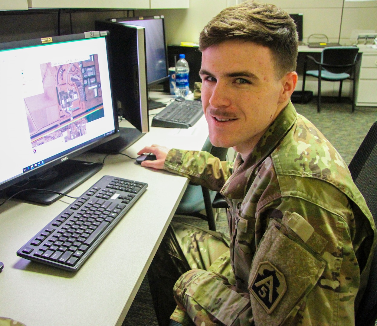 Pfc. Matthew J. McGill, 543rd Engineer Detachment geospatial engineer, reviews geospatial imagery for a port of entry along the border from Texas to California. The detachment began their part of the border support mission by analyzing maps and refining data to paint a picture of the operating areas for commanders and decision-makers to better visualize their areas of operations.