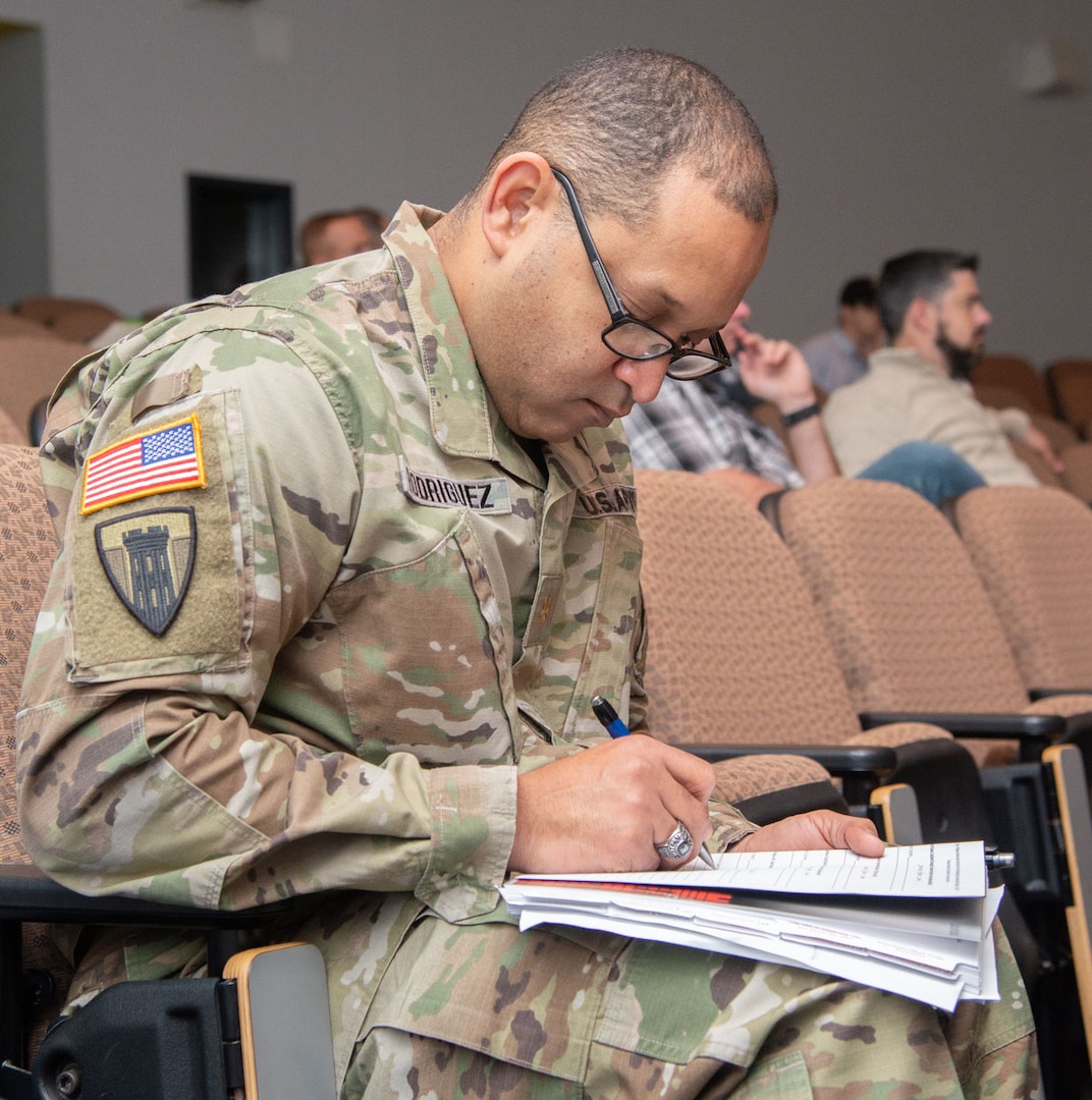 Maj. Juan Rodriquez of the National Guard Bureau Instillations and Environmental office in Arlington, Va., takes notes during a presentation on inspections during the State Contract Management/Business Manager’s Certification Construction Facilities Maintenance Office (CFMO) 102 course held at Camp Dawson, Kingwood, W.Va., Dec. 6, 2018. Students from around the U.S. participated in the course which provided students a deep-dive into contracting topics such as liability claims, bonding and insurance, contract terminations, contractor claims, delays and remedies, payments and closeout, and ethics.