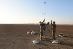 Tech. Sgt. Kyle Lyons, 380th Expeditionary Operational Support Squadron NCOIC, weather operations, Airman 1st Class Brendan Howley, 380th EOSS weather operations technician, perform maintenance on the AN/TMQ-53 Tactical Meteorological Observing Systems at Al Dhafra Air Base, United Arab Emirates, Dec. 3, 2018. The 380th Expeditionary Operational Support Squadron weather operations provides the 380th Air Expeditionary Wing with decision quality environmental information to optimize decisive airpower. (U.S. Air Force photo by Tech. Sgt. Darnell T. Cannady)