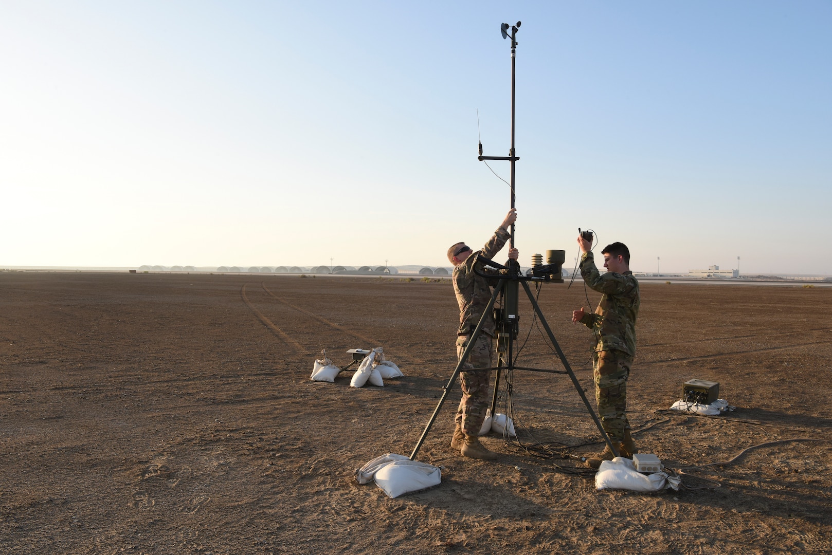 Tech. Sgt. Kyle Lyons, 380th Expeditionary Operational Support Squadron NCOIC, weather operations, Airman 1st Class Brendan Howley, 380th EOSS weather operations technician, perform maintenance on the AN/TMQ-53 Tactical Meteorological Observing Systems at Al Dhafra Air Base, United Arab Emirates, Dec. 3, 2018. The 380th Expeditionary Operational Support Squadron weather operations provides the 380th Air Expeditionary Wing with decision quality environmental information to optimize decisive airpower. (U.S. Air Force photo by Tech. Sgt. Darnell T. Cannady)