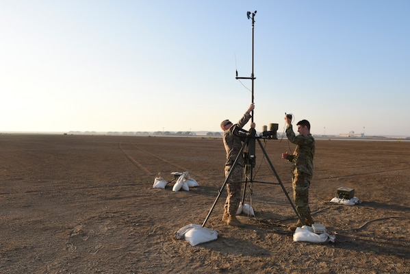 Tech. Sgt. Kyle Lyons, 380th Expeditionary Operational Support Squadron NCOIC, weather operations, Airman 1st Class Brendan Howley, 380th EOSS weather operations technician, perform maintenance on the AN/TMQ-53 Tactical Meteorological Observing Systems at Al Dhafra Air Base, United Arab Emirates, Dec. 3, 2018. The 380th Expeditionary Operational Support Squadron weather operations provides the 380th Air Expeditionary Wing with decision quality environmental information to optimize decisive airpower. (U.S. Air Force photo by Tech. Sgt. Darnell T. Cannady)