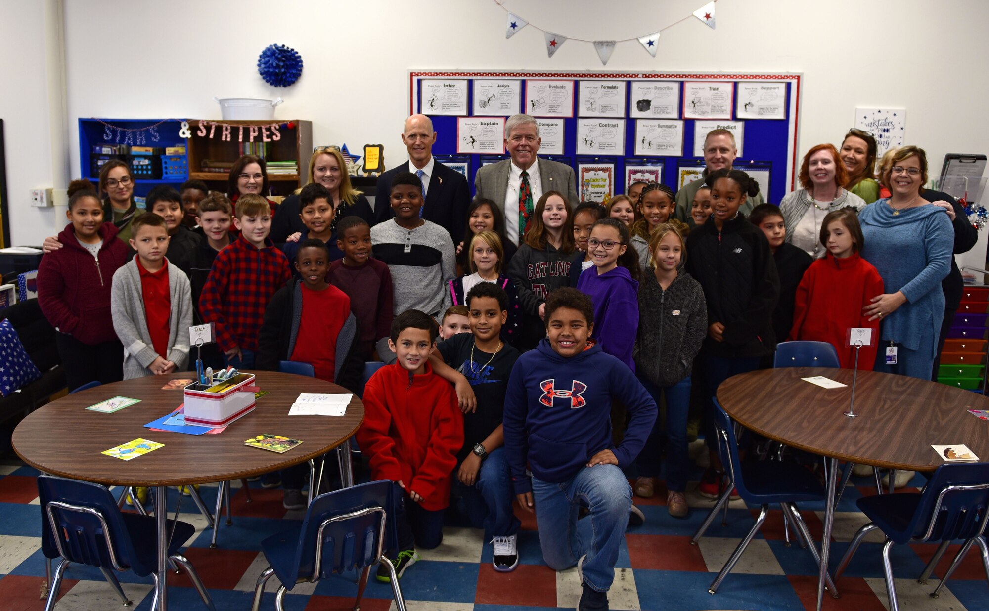 Gov. Rick Scott, current governor of Florida, and Col. Brian Laidlaw, 325th Fighter Wing commander, pose for a group photo alongside students, faculty and representatives from Bay District Schools while at the re-opening of Tyndall Elementary School near Tyndall Air Force Base, Fla., Dec. 10, 2018. The re-opening came two months after Hurricane Michael ravaged Tyndall and the surrounding Florida panhandle. (U.S. Air Force photo by Senior Airman Isaiah J. Soliz)