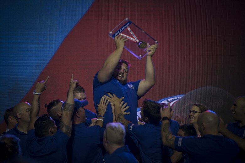Rob Hufford, Department of Defense Warrior Games athlete and Team Air Force member, is lifted up by his teammates after being awarded the "heart of the team" award for Team Air Force durinh the Games closing ceremony at the U.S. Air Force Academy, Colorado Springs, Colorado, June 9, 2018. To determine the recipients of the heart of the team award, athletes representing each service team voted for the member of their team who they believe embodies the heart of their team. (U.S. Air Force Photo by Senior Airman Dennis Hoffman)