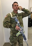 New York Army National Guard Maj.Robert Freed poses with a mock M-4 and block of wood replicating a radio handset, as photos of his pose are taken at Studio EIS in Brooklyn, N.Y., on Nov. 15, 2018. Freed is one of six New York National Guard Soldiers who served as models for life-size figures that will be part of two exhibits at the National Museum of the United States Army when it opens in 2020. The figure Freed served as a model is of a platoon leader in Afghanistan calling for air support.