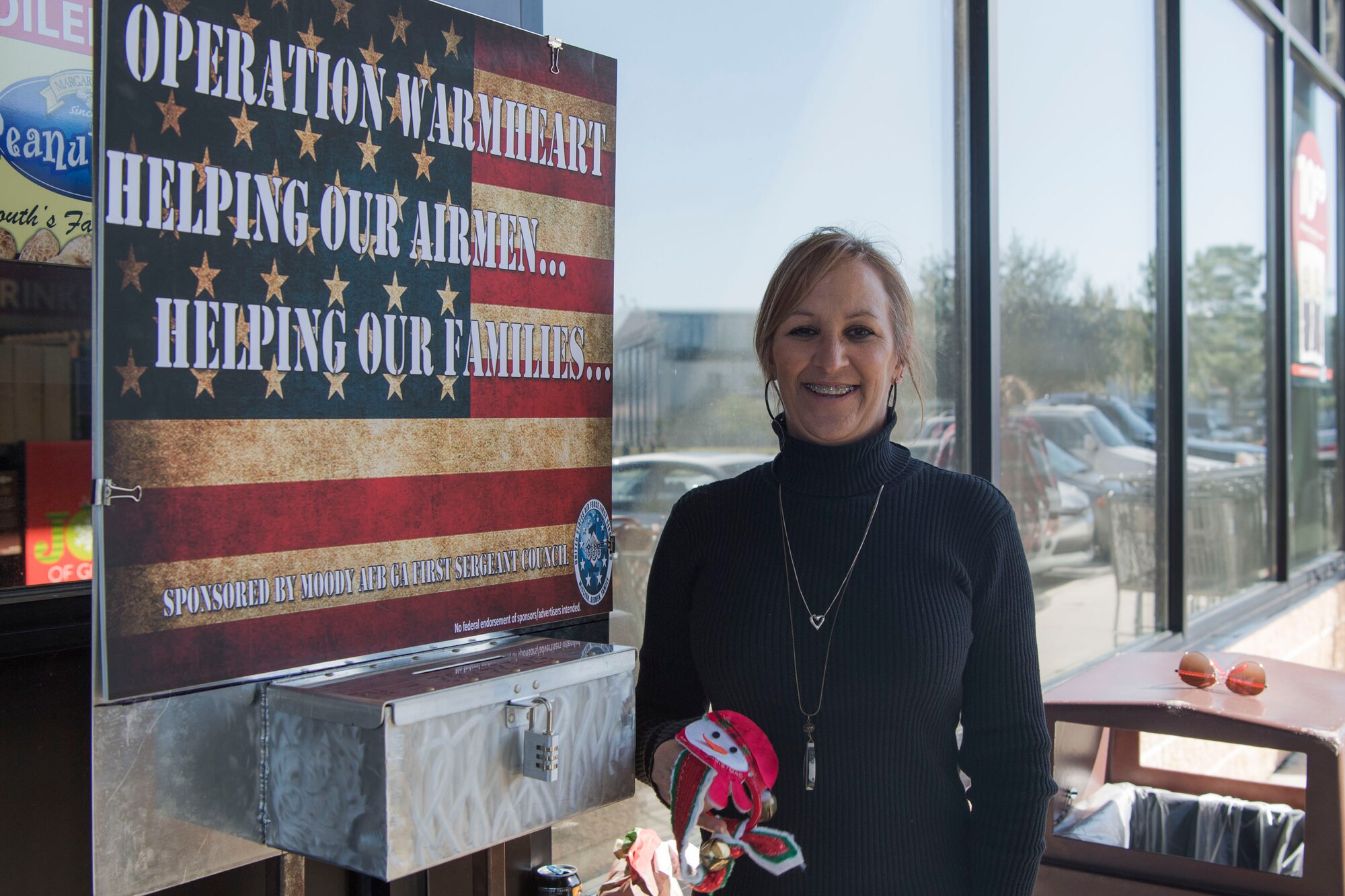 Kelly Denson, 71st Rescue Squadron unit program coordinator, poses for a photo during Ring the Bell, Dec. 4, 2018, at Moody Air Force Base, Ga. Operation Warmheart is a private organization ran by the first sergeants of Moody. The Ring the Bell event is the only fundraiser the first sergeants do to support Operation Warmheart, which allows first sergeants of Moody to give out thousands of dollars in gift cards to Airmen in need. (U.S. Air Force photo by Airman Taryn Butler)