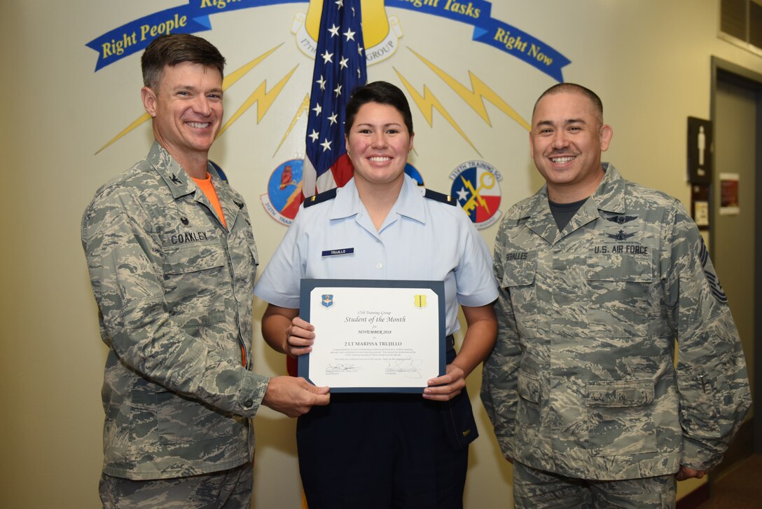 U.S. Air Force Col. Thomas Coakley, 17th Training Group commander, presents the 315th Training Squadron Officer Student of the Month award to 2nd Lt. Marissa Trujillo, 315th TRS student, at Brandenburg Hall on Goodfellow Air Force Base, Texas, Dec. 7, 2018. The 315th TRS’s vision is to develop combat-ready intelligence, surveillance and reconnaissance professionals and promote an innovative squadron culture and identity unmatched across the U.S. Air Force. (U.S. Air Force photo by Senior Airman Scott Jackson/Released)