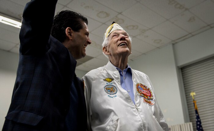 Ed Hall, Pearl Harbor Survivor, reacts to his name being displayed on a static aircraft Dec. 7, 2018 in the Threat Training Facility at Nellis Air Force Base, Nevada. Hall said his trip to the Threat Training Facility was interesting and entertaining. (U.S. Air Force photo by Airman 1st Class Bailee A. Darbasie)