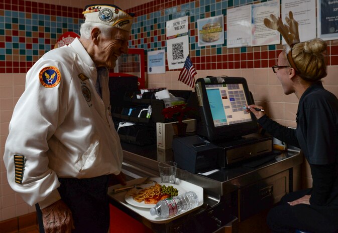 Ed Hall, Pearl Harbor Survivor, purchases a meal Dec. 7, 2018 in the Crosswinds Dining Facility at Nellis Air Force Base, Nevada. Hall sat down to eat with Airmen and spoke to them about his experience during the attacks on Pearl Harbor. (U.S. Air Force photo by Airman 1st Class Bailee A. Darbasie)