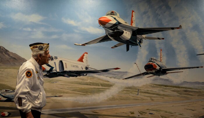 Ed Hall, Pearl Harbor Survivor, observes a mural of the Thunderbirds Dec. 7, 2018 in the Thunderbird Museum at Nellis Air Force Base, Nevada. Hall tested a superstition that stated if he walked from one side of the mural to the other, the jets would appear to fly towards him. (U.S. Air Force photo by Airman 1st Class Bailee A. Darbasie)