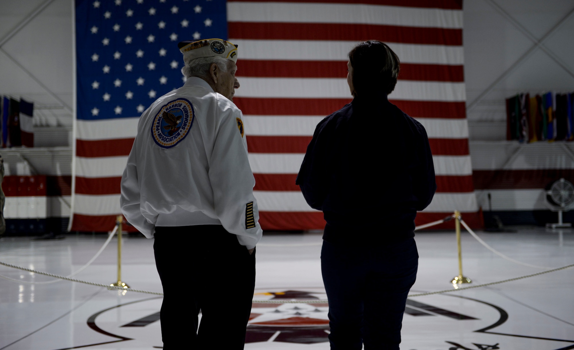 Ed Hall, Pearl Harbor Survivor, speaks with Master Sgt. Christine Powers, Public Affairs superintendent for the Thunderbirds, Dec. 7, 2018 in the Thunderbirds Hangar at Nellis Air Force Base, Nevada. Hall toured the Thunderbirds Museum and explored the hangar. (U.S. Air Force photo by Airman 1st Class Bailee A. Darbasie)