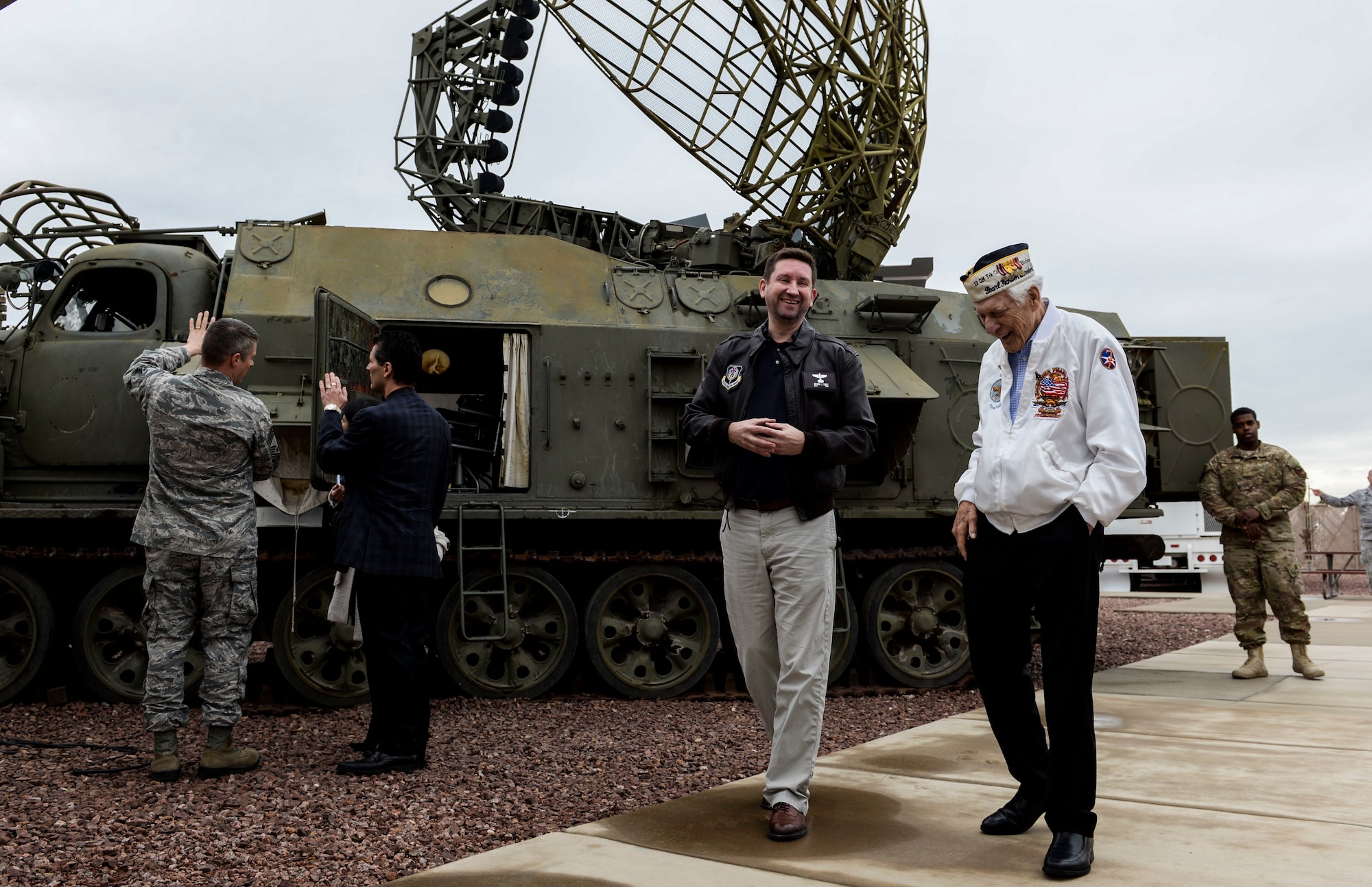 Ed Hall, Pearl Harbor Survivor, walks with Bryan Casey, Threat Training Facility senior intelligence instructor Dec. 7, 2018 in the Threat Training Facility at Nellis Air Force Base, Nevada. Hall’s trip to the Threat Training Facility was one of many stops on his base tour. (U.S. Air Force photo by Airman 1st Class Bailee A. Darbasie)