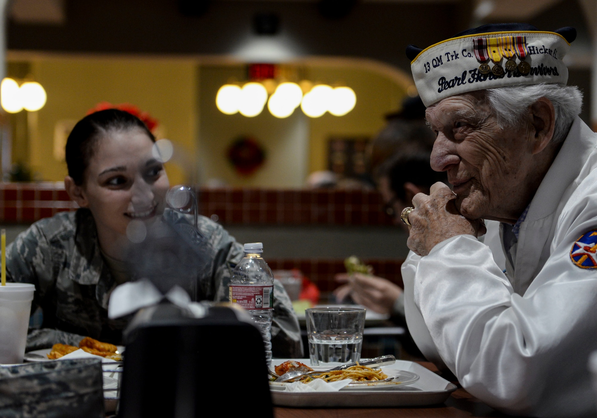 Ed Hall, Pearl Harbor Survivor, has lunch with Airmen Dec. 7, 2018 in the Crosswinds Dining Facility at Nellis Air Force Base, Nevada. Airmen assigned to various squadrons flocked to Hall to thank him for his service. (U.S. Air Force photo by Airman 1st Class Bailee A. Darbasie)