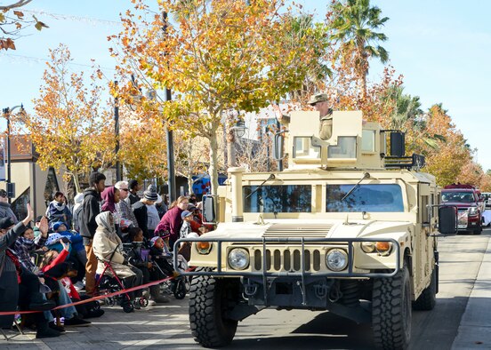 Col. Jeffry Hollman, 412th Mission Support Group commander, waves at parade-goers while on a Humvee during the Sleigh Rides through the City parade in Lancaster, California, Dec. 1. Hollman represented Edwards Air Force Base in the parade through downtown Lancaster as one of more than 100 other entries which included floats, marching bands and classic and modern cars. (U.S. Air Force photo by Giancarlo Casem)