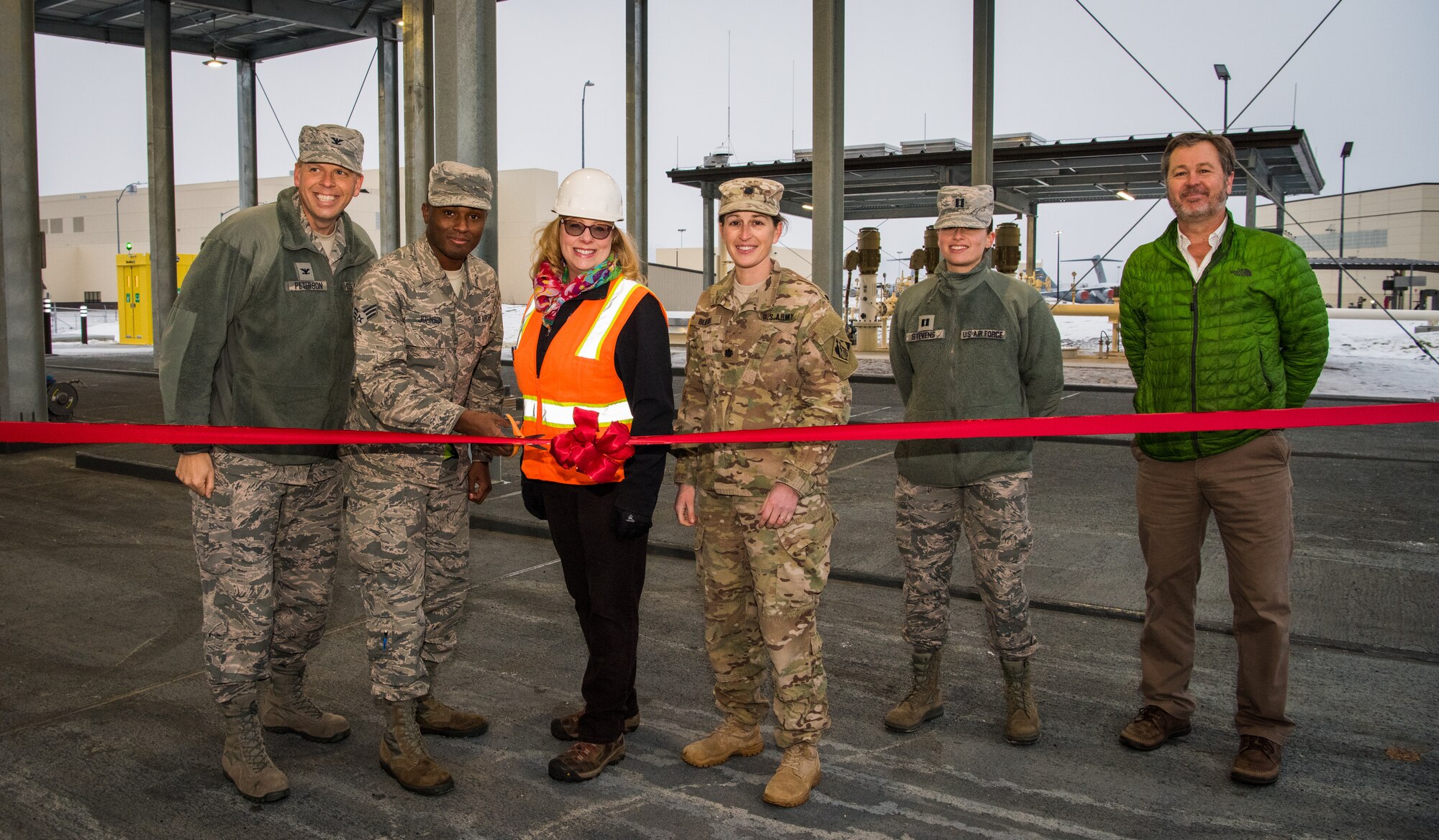 Arctic warriors pose for a photo at a ribbon-cutting ceremony at Joint Base Elmendorf-Richardson, Alaska, Dec.6, 2018. The ceremony served as the unveiling of a new state-of-the-art fuel offloading facility called a JP-8 Alternate Offload Header, providing JBER a new alternate fuel receipt capability