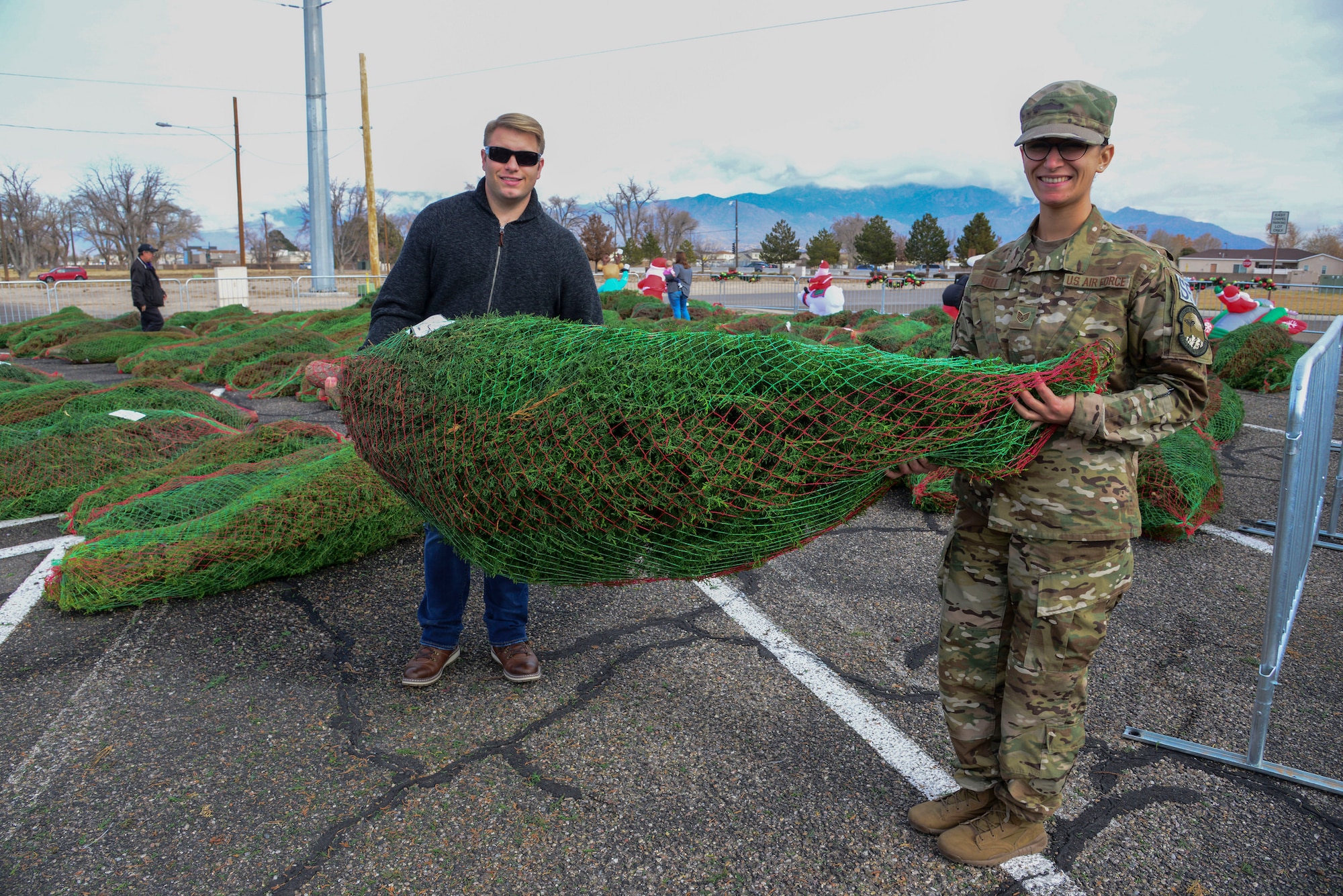 Staff Sgt. Frankie Gill, 377th Security Forces Squadron, and her husband Cody Gill pose with a Christmas tree they picked out during the Trees for Troops event Dec. 7 at the base chapel here. The two-day event provided free trees for members of Team Kirtland. Last year the program delivered 17,400 Christmas trees to 70 U.S. military bases; 250 trees delivered to four international bases; and is in its 14th year. (U.S. Air Force photo by Jessie Perkins)