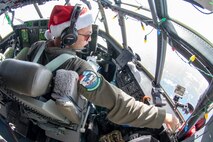 1st. Lt. Emery Gumapas, 36th Airlift Squadron pilot out of Yokota Air Base, Japan, looks out of the window of a C-130J Super Hercules during Operation Christmas Drop 2018 en route to the island of Nama, Federated States of Micronesia (FSM), Dec. 10, 2018. The flight, carrying Commander, U.S. Indo-Pacific Command, Adm. Phil Davidson and local leaders from the FSM, gave the passengers a firsthand experience into how the aircrews that attend OCD execute the mission.