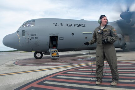 Senior Airman Kylie Hanni, 36th Airlift Squadron loadmaster, waits outside of a C-130J Super Hercules to greet Commander, U.S. Indo-Pacific Command, Adm. Phil Davidson on the island of Chuuk, Federated States of Micronesia during Operation Christmas Drop 2018, Dec. 10, 2018. In its 67th year, OCD is the world’s longest running airdrop training mission providing critical supplies to 56 Micronesian islands impacting approximately 20,000 people across 1.8 million square nautical miles of operating area.