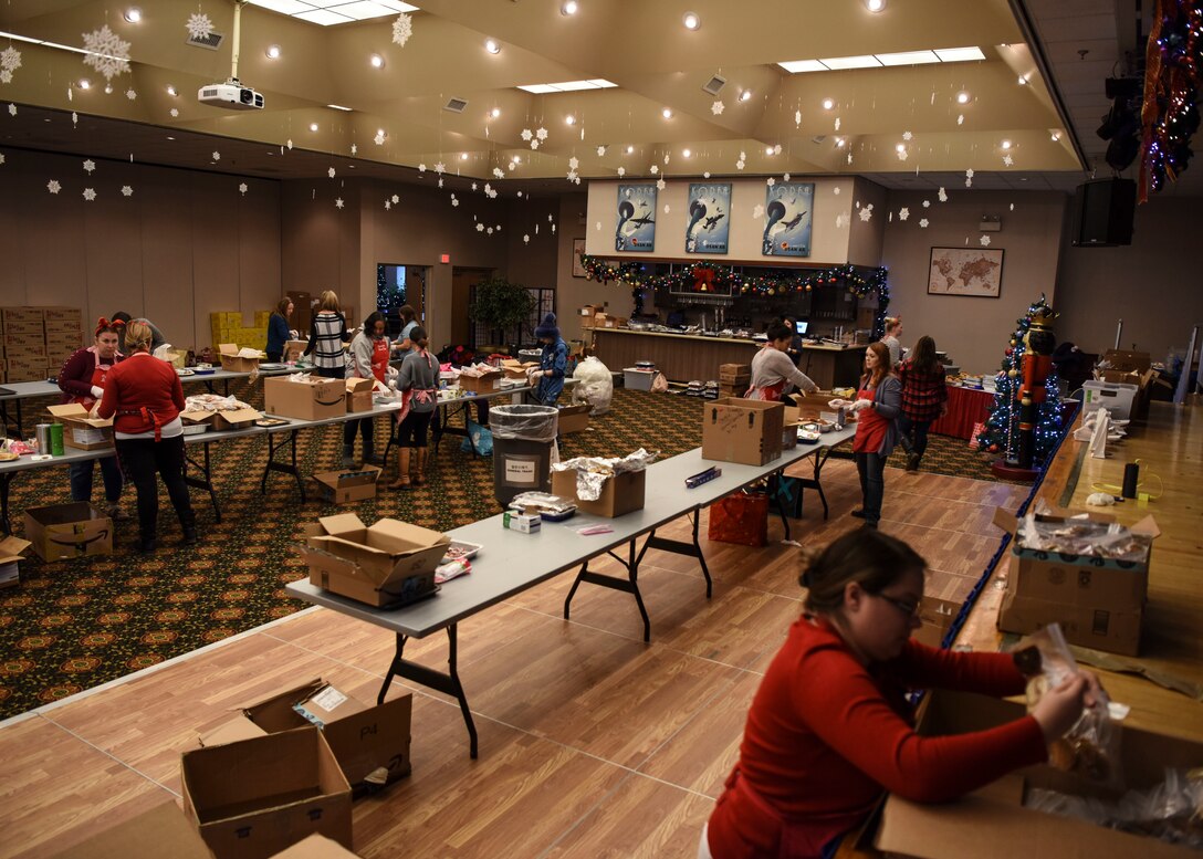 Volunteers come together in the Osan Officer’s Club to prepare cookies for Operation Sweet Treat at Osan Air Base, Republic of Korea, Dec. 10, 2018. The volunteers spent the day bagging more than 50,000 cookies and treats to be sent out for delivery to unaccompanied service members across the Korean Peninsula. (U.S. Air Force Airman 1st Class Ilyana A. Escalona)