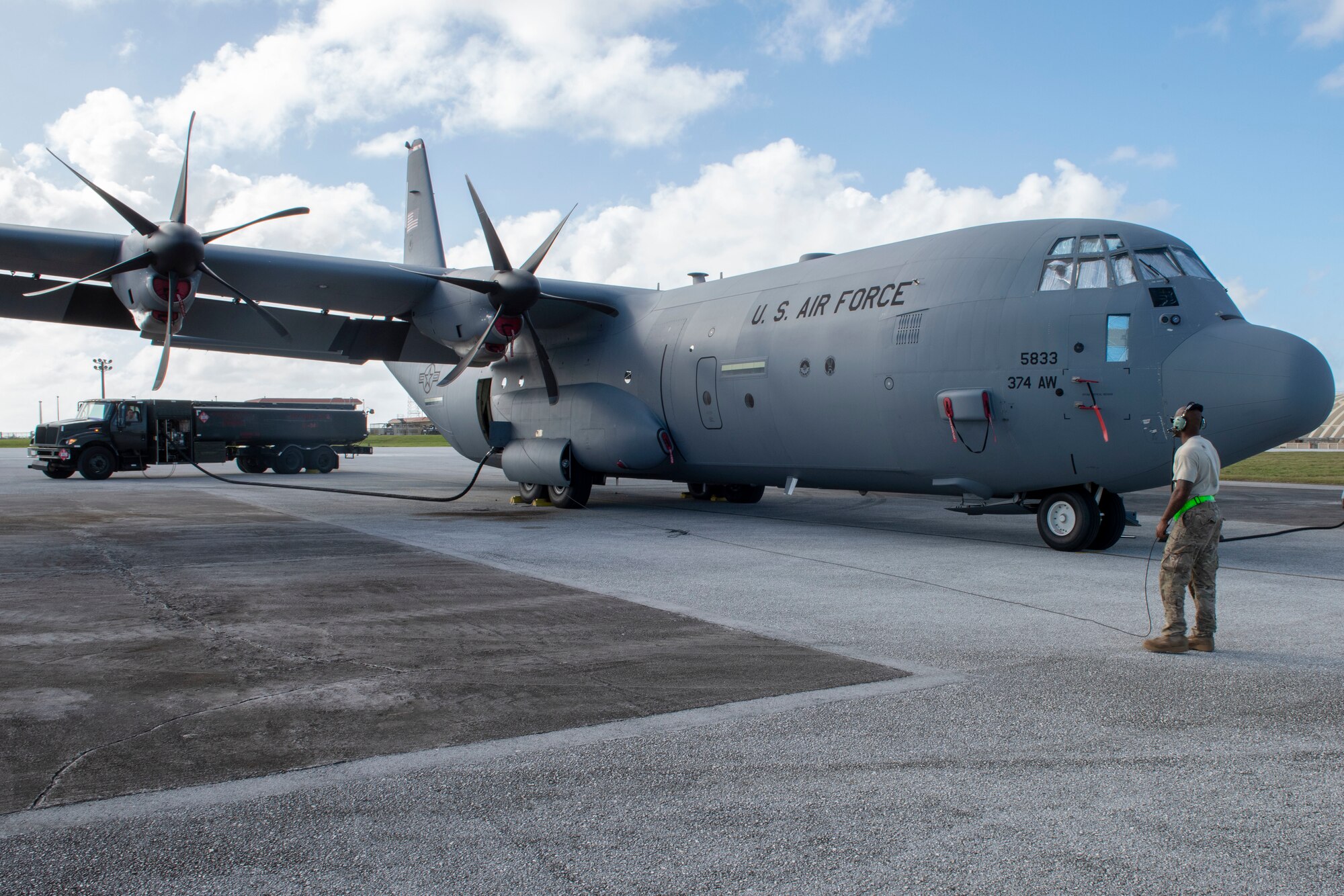 Staff Sgt. Christopher Canto, 374th Aircraft Maintenance Squadron flying crew chief, communicates with the rest of his team aboard a C-130J Super Hercules via radio during the refueling process at Operation Christmas Drop 2018 at Andersen Air Force Base, Guam, Dec. 9, 2018.