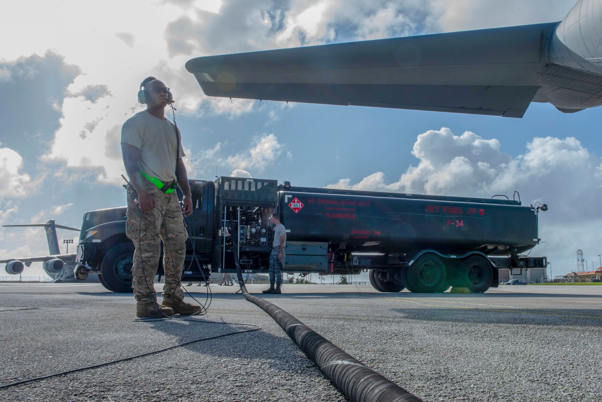 Staff Sgt. Christopher Canto, 374th Aircraft Maintenance Squadron flying crew chief, communicates with the rest of his team aboard a C-130J Super Hercules via radio during the refueling process at Operation Christmas Drop 2018 at Andersen Air Force Base, Guam, Dec. 9, 2018.