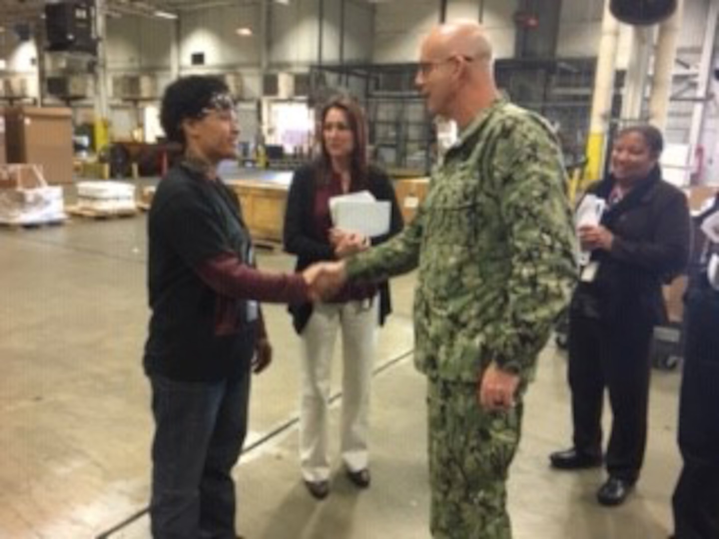 DLA Distribution commander, Navy Rear Adm. Kevin M. Jones meets with DLA Distribution Red River, Texas employees and division chiefs during his inaugural visit to the distribution center.