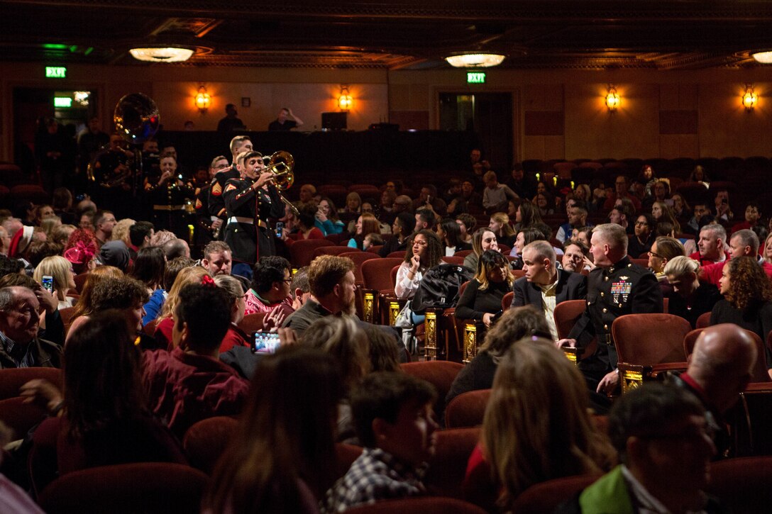 Marine Forces Reserve Band members, perform while entering the Saenger Theatre for the annual holiday concert in New Orleans, Dec. 9, 2018. The performance was one of multiple holiday concerts the band arranged throughout December to promote the Marine Corps Reserve Toys for Tots program, which donates toys to less fortunate children in the community. (U.S. Marine Corps photo by Lance Cpl. Samantha Schwoch)