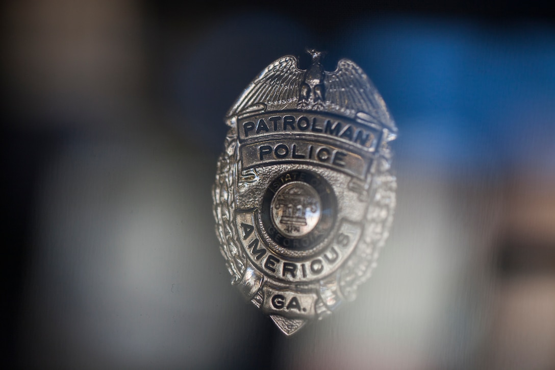 The police badge worn by Nicholas Smarr the day he was killed in the line of duty while serving as a police officer for the Americus Police Department, is displayed at the department in Americus, Ga., Dec. 7, 2018. Smarr and fellow officer Jody Smith were killed in action when responding to a call in Americus on Dec. 7, 2016; Smarr was also a Lance Cpl. in the Marine Corps Reserve. (U.S. Marine Corps photo by Cpl. Niles Lee)