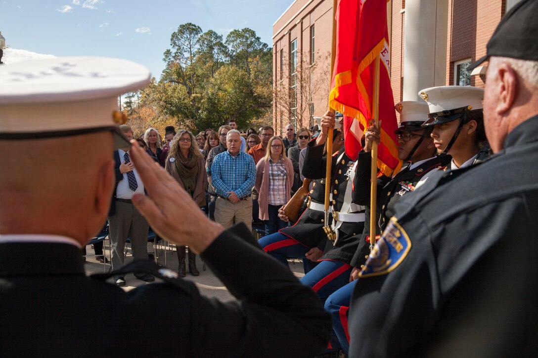 The family of Lance Cpl. Nicholas Smarr stand during the retiring of the colors at his Navy and Marine Corps Medal presentation ceremony at Georgia Southwestern State University in Americus, Ga., Dec. 7, 2018. Smarr, a Reserve Marine, was posthumously awarded the Navy and Marine Corps Medal for his actions that cost him his life two years ago while serving as a police officer for the Americus Police Department. (U.S. Marine Corps photo by Cpl. Niles Lee)