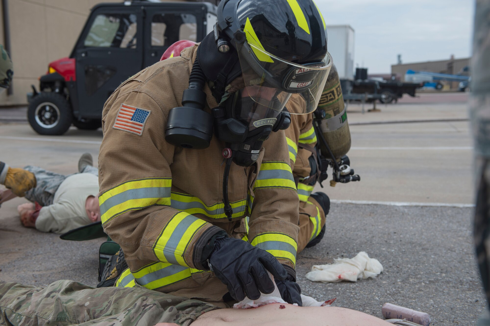 U.S. Air Force Senior Airman Dylan Rousseau, a fire protection member assigned to the 97th Civil Engineer Squadron, performs Emergency Medical Technician (EMT) procedures on a victim of a simulated chemical attack