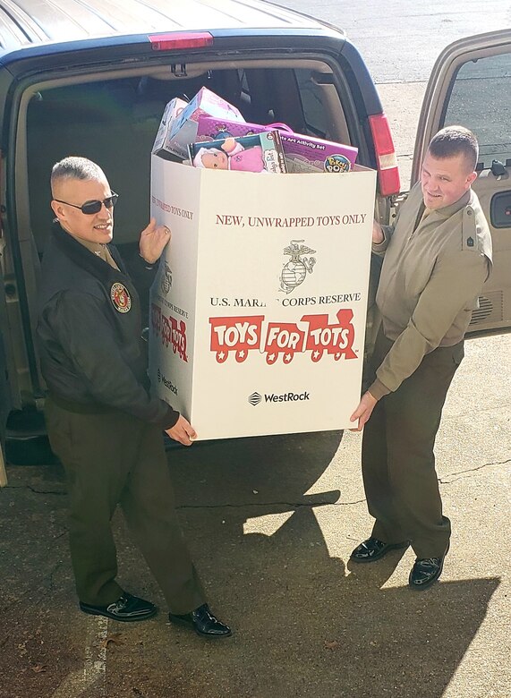 Marine Col. William C. Bentley III, commanding officer of Marine Corps Base Quantico (MCBQ) and Sgt. Maj. Michael W. Hensley, sergeant major of MCBQ, delivers the base's donations to the Toys for Tots Northern Virginia campaign's warehouse in Fredericksburg, December 6, 2018