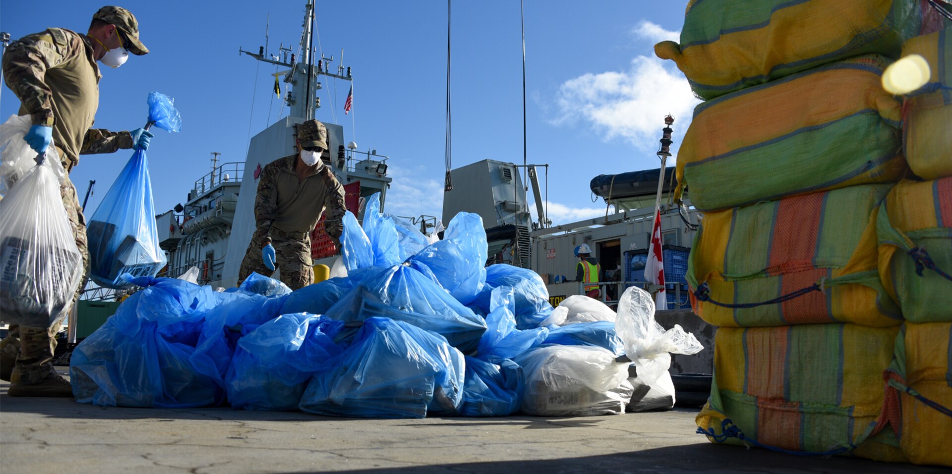 Crew members from the Coast Guard Pacific Tactical Law Enforcement Team offloads approximately 5,100 pounds of suspected cocaine from The Royal Canadian Navy HMCS Edmonton at Naval Base San Diego Dec. 7th, 2018.