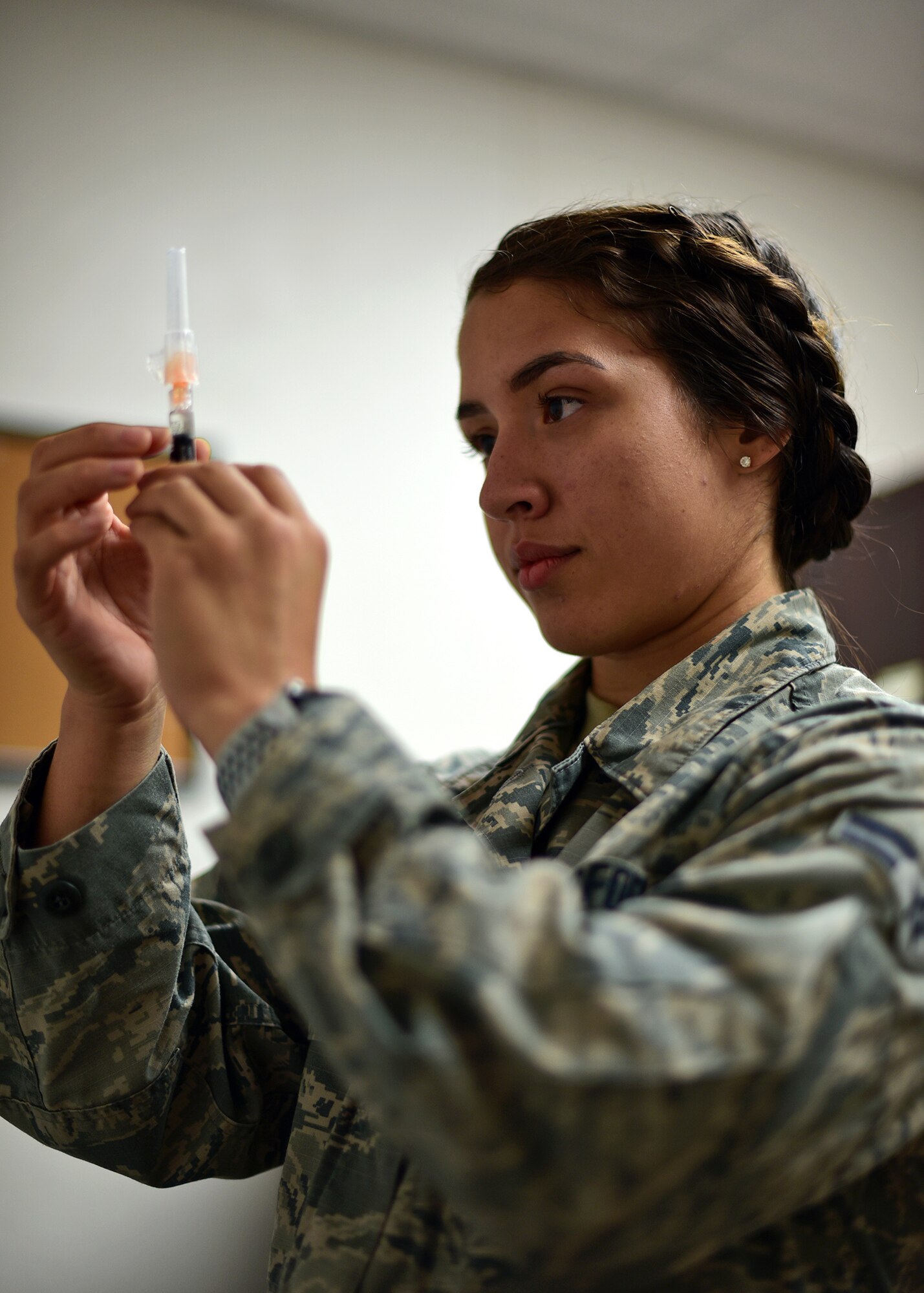 U.S. Air Force Airman 1st Class Ashley Deliz-Aguilera, 325th Medical Operations Squadron medical technician, prepares a flu shot while at Tyndall Air Force Base, Fla., Dec. 8, 2018. Previously evacuated due to Hurricane Michael, Deliz-Aguilera returned to a devastated base and was eager to help in the rebuilding process. (U.S. Air Force photo by Senior Airman Isaiah J. Soliz)