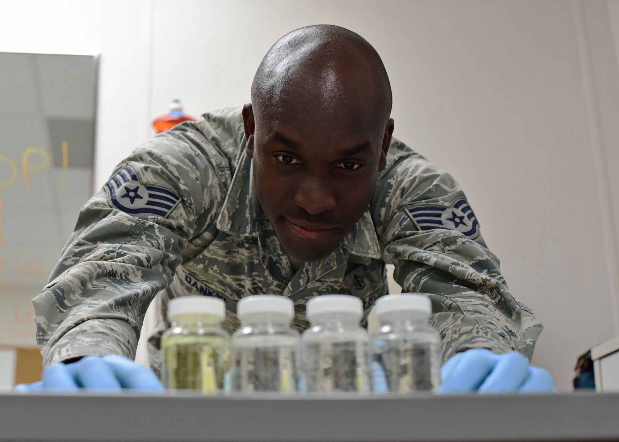 U.S. Air Force Staff Sgt. Kwadwo Dankyi, 325th Aerospace Medicine Squadron bioenvironmental engineering technician, examines water samples while at Tyndall Air Force Base, Fla., Dec. 8, 2018. Dankyi returned in the wake of Hurricane Michael to a ravaged installation and was eager to begin helping in the rebuilding process. (U.S. Air Force photo by Senior Airman Isaiah J. Soliz)