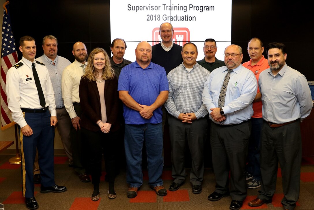 Maj. Justin Toole, U.S. Army Corps of Engineers Nashville District deputy commander, joins the 13 graduates of the 2018 Supervisory Training Program class for the last session and graduation ceremony Dec. 4, 2018 at the Nashville District Headquarters in Nashville, Tenn. (USACE photo by Mark Abernathy)