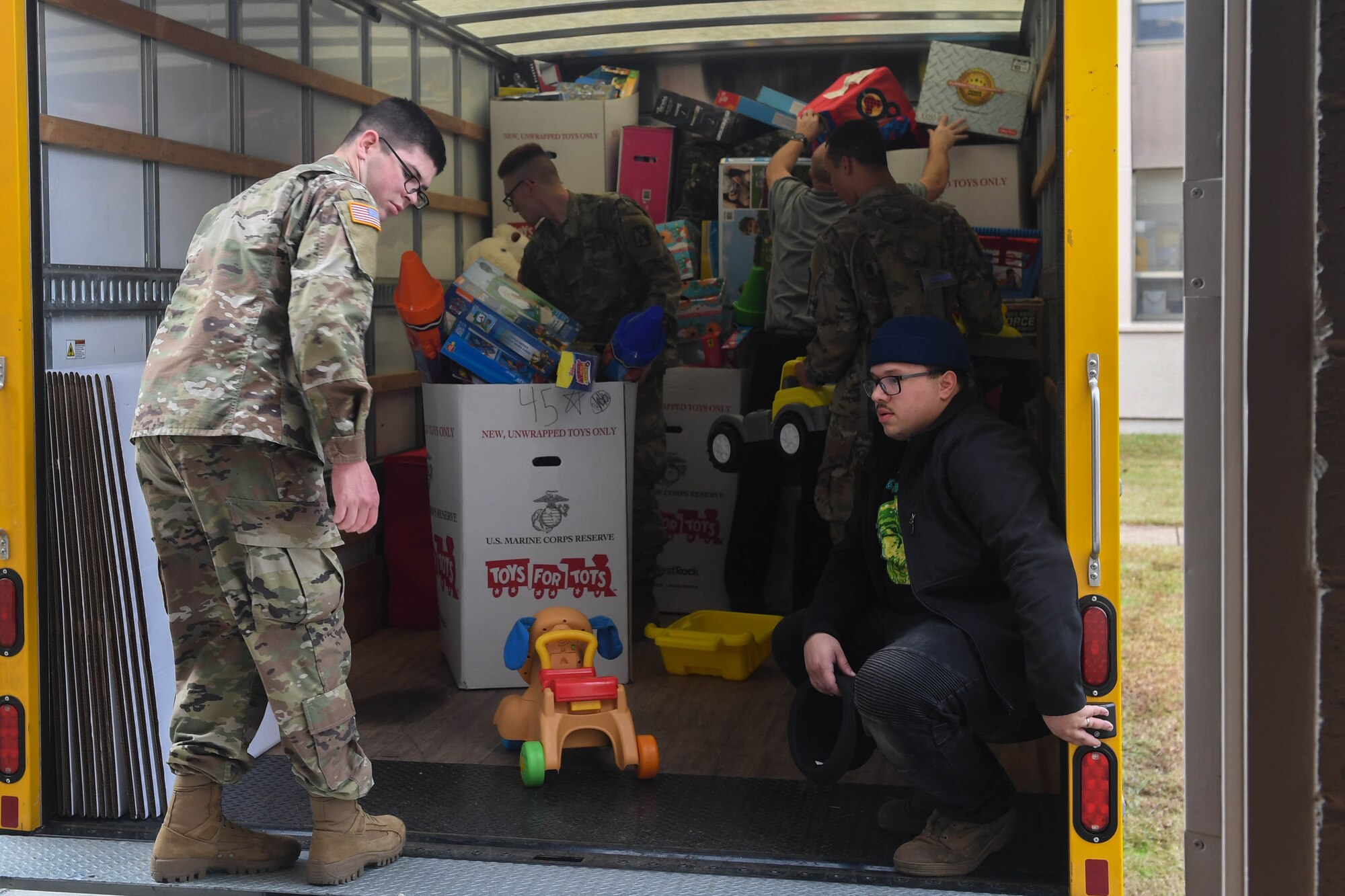 U.S. Army Soldiers and U.S. Marine Corps Marines load boxes of toys onto a truck during the Toys for Tots donation drive at Joint Base Langley-Eustis, Virginia, Dec. 3, 2018. Some of the toys donated include bicycles, games and toy cars. (U.S. Air Force photo by Senior Airman Derek Seifert)
