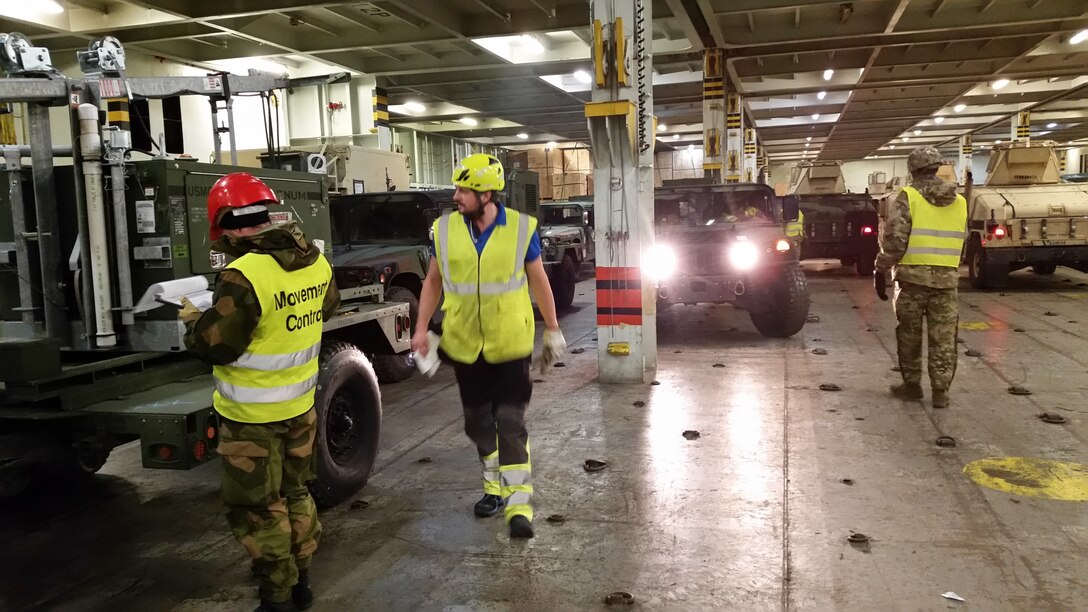 U.S. Marines with II Marine Expeditionary Force, maneuver vehicles to off-load them from American Roll-on Roll-off Carrier 
Resolve for NATO exercise Trident Juncture in Hammernesodden, Norway, Sept. 23, 2018. Marines and service members from the Norwegian Armed Services unloaded nearly 200 military vehicles and more than 70 containers with military equipment in two days despite cold weather with periods of rain and sleet. (Photo by Kyle Soards)