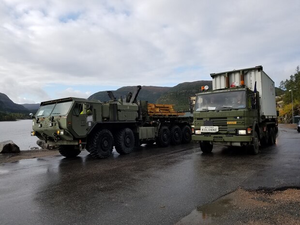 U.S. Marines with II Marine Expeditionary Force, maneuver vehicles after off-load equipment for NATO exercise Trident Juncture from American Roll-on Roll-off Carrier Resolve in Hammernesodden, Norway, Sept. 24, 2018. Marines and service members from the Norwegian Armed Services unloaded nearly 200 military vehicles and more than 70 containers with military equipment in two days despite cold weather with periods of rain and sleet. (Photo by Kyle Soard)