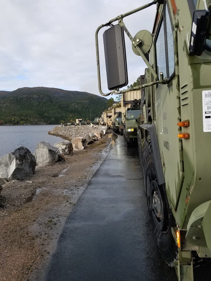 U.S. Marines with II Marine Expeditionary Force, maneuver vehicles after off-loading them from the American Roll-on Roll-off Carrier Resolve for NATO exercise Trident Juncture in Hammernesodden, Norway, Sept. 24, 2018. Marines and service members from the Norwegian Armed Services unloaded nearly 200 military vehicles and more than 70 containers with military equipment in two days despite cold weather with periods of rain and sleet.  (Photo by Kyle Soard)
