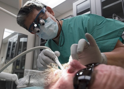 Lt. Col. (Dr.) Young J. Honnlee, 59th Medical Wing maxillofacial prosthodontics fellow, evaluates the inside of a patient’s mouth at San Antonio Military Medical Center, Joint Base San Antonio-Fort Sam Houston, Texas. Honnlee prepares to make impressions of the patient’s teeth. (U.S. Air Force photo by Staff Sgt. Kevin Iinuma)