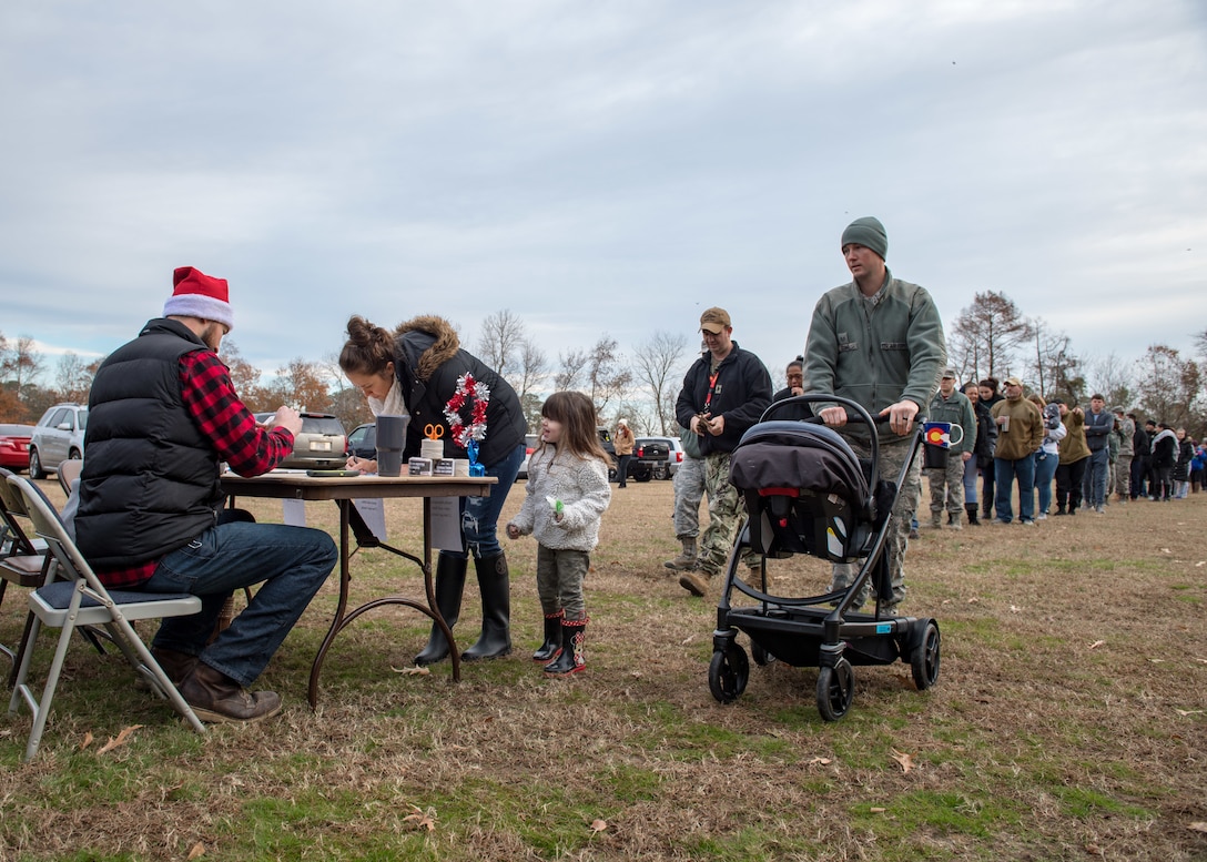 Military families line up to receive a free Christmas tree during the Christmas SPIRIT Foundation’s Trees for Troops program at Bethel Park, Hampton, Virginia, Dec. 7, 2018.