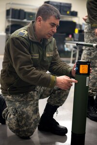 Chilean Air Force Lt. Col. Claudio Montiglio, medical health officer, looks at a Critical Care Air Transport Team’s oxygen supply bottle on Dec. 7, at Camp Bramble on Joint Base San Antonio-Lackland, Texas. Each CCATT carries roughly 560 pounds of gear, enough to continue the level of acute care for three critically ill patients up to 24-hours. (U.S. Air Force photo by Kiley Dougherty)