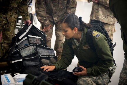 Chilean Air Force Capt. Vivian Leiva, medical health officer, looks through a bag of medical supplies used on Critical Care Air Transport missions on Dec. 7, at Camp Bramble on Joint Base San Antonio-Lackland, Texas. Each CCAT Team carries roughly 560 pounds of gear, enough to continue the level of acute care for three critically ill patients up to 24-hours. (U.S. Air Force photo by Kiley Dougherty)