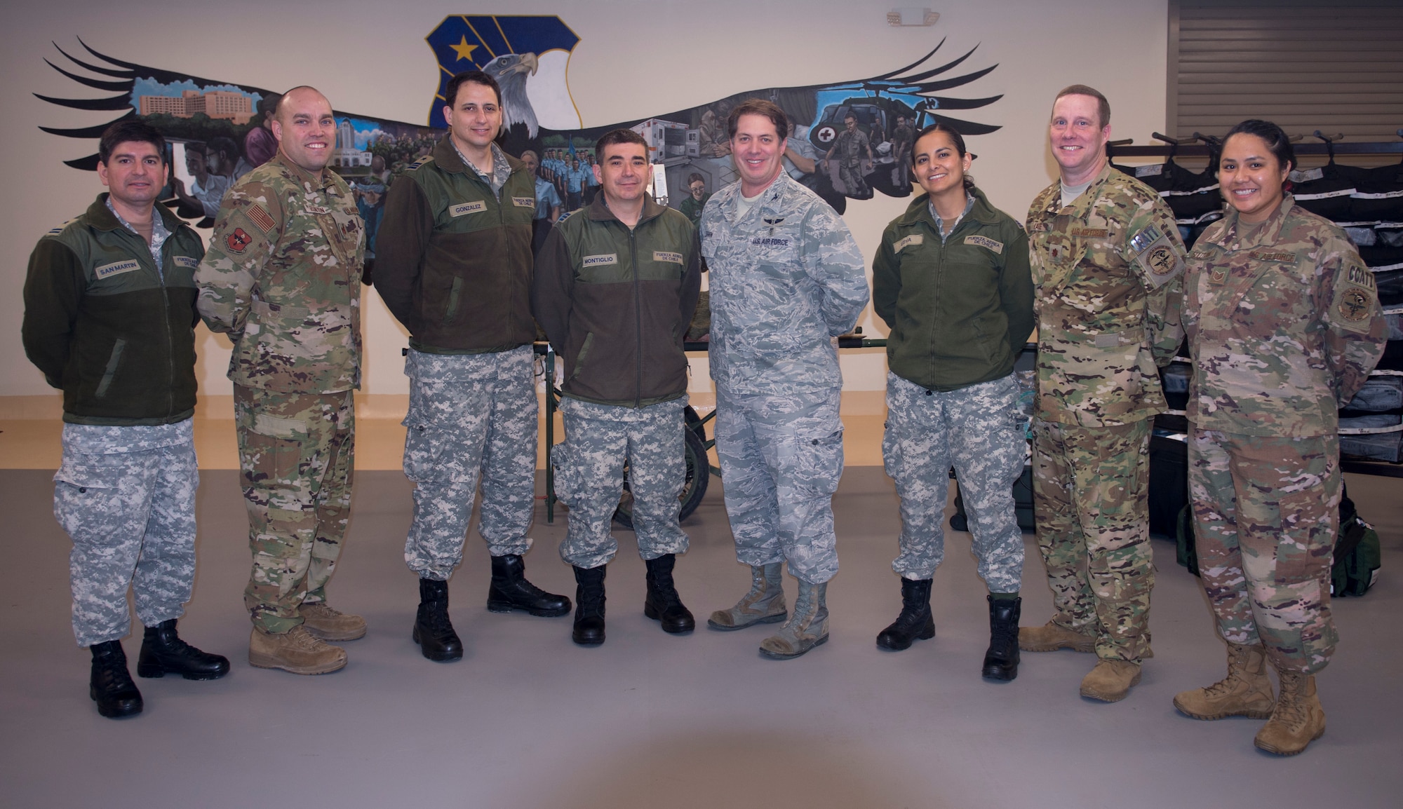 Medical health officers from the Chilean Air Force pose for a photo with members from the 59th Medical Wing’s Critical Care Air Transport Team on Dec.7, at Camp Bramble on Joint Base San Antonio-Lackland, Texas. The Chileans toured Wilford Hall’s Simulation Center, which provides a hands-on learning environment through the use of high-fidelity mannequins and virtual reality simulators, before visiting Camp Bramble, the CCATT training and mission staging location. (U.S. Air Force photo by Kiley Dougherty)