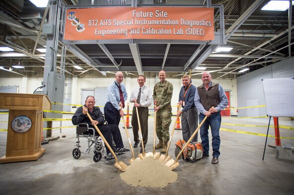 Edwards and 812th Aircraft Instrumentation Test Squadron leadership pose for the ceremonial ground breaking photo Dec. 3 inside Bldg. 1600 where a new 812th AITS Special Instrumentation Diagnostics Engineering and Calibration Lab will be constructed. Pictured from left to right: Randy Beckett, 412th Civil Engineer Group retired deputy base civil engineer; James Judkins, 412th CEG director and base civil engineer; Richard Backs, 412th Test Wing Plans and Programs; Brig. Gen. E. John Teichert, 412th TW commander; Alan Colthorp, 812th AITS director; and John Bennett, Modular Management Group chief operations officer. (U.S. Air Force photo by Kyle Larson)