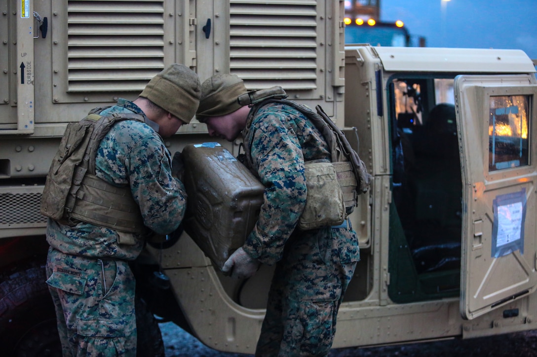 U.S. Marines with II Marine Support Battalion, II Marine Information Group, refuel a high mobility multipurpose wheeled vehicle during a convoy operation for Exercise Trident Juncture 18 in Norway, Nov. 2, 2018. Trident Juncture 18 demonstrates II Marine Expeditionary Force’s ability to deploy, employ, and redeploy the Marine Air Ground Task Force while improving interoperability with NATO allies and partners. (U.S. Marine Corps photo by Cpl. Patrick Osino)