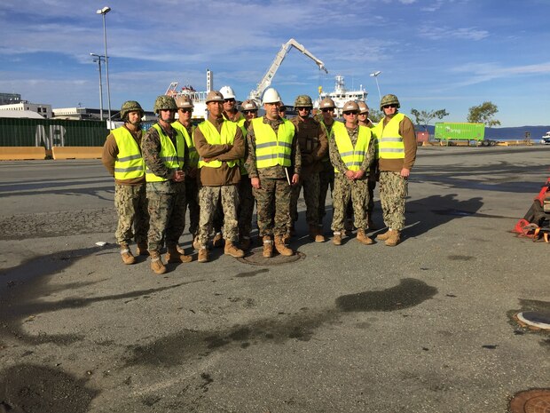 U.S. Marine Col. John Sullivan, 2d Marine Expeditionary Brigade chief of staff, stands with U.S. Marines and Sailors who worked together to offload equipment that will be used during Trident Juncture 18 at Trondheim Port, Norway, on Oct. 11, 2018. Trident Juncture 18 enhances the U.S. and NATO Allies' abilities to work together collectively to conduct military operations under challenging conditions. (U.S. Marine Corps photo by Maj. Jordan Cochran)