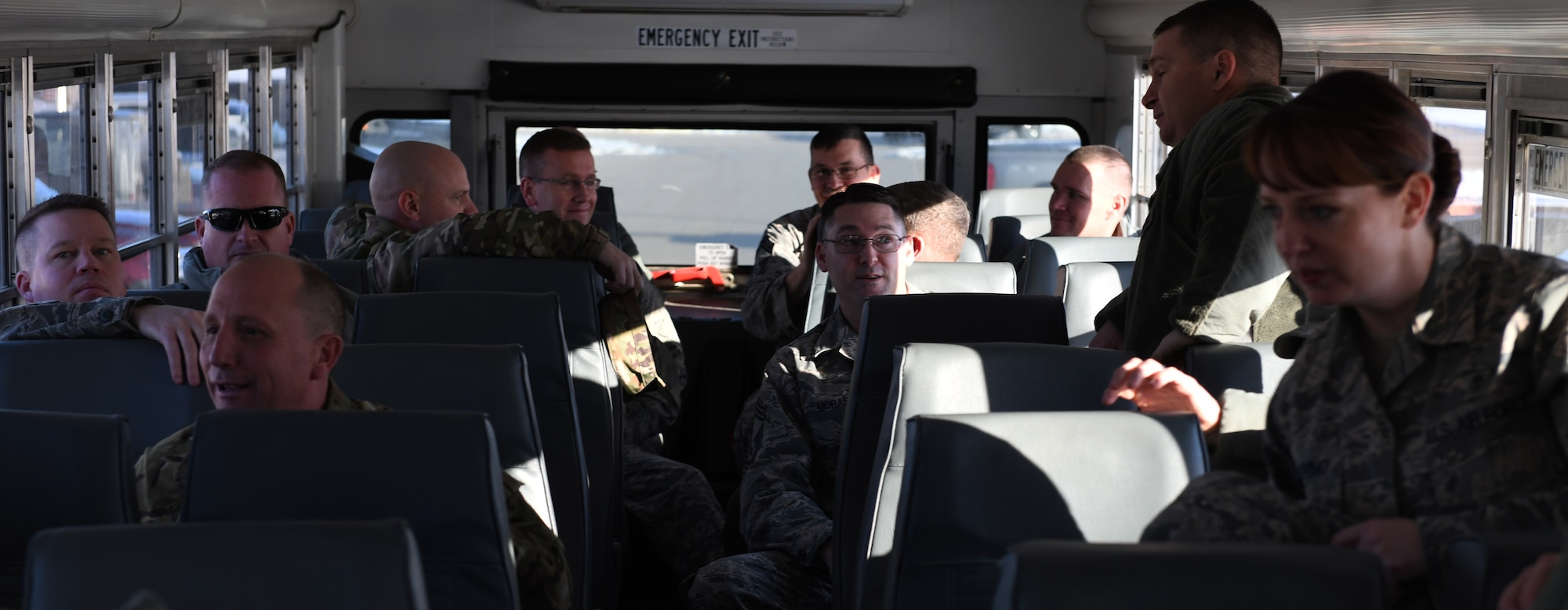 The 28th Bomb Wing chief master sergeants and commanders ride a bus at Ellsworth Air Force Base, S.D., Dec. 4, 2018. The chief’s bus took a trip to the 28th Security Forces Squadron to congratulate Senior Master Sgt. Jesse Frank, the 28th SFS operations superintendent, on earning the title of chief master sergeant. (U.S. Air Force photo by Airman 1st Class Thomas Karol)