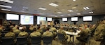 U.S. Army Maj. Gen. Bill Hall, JTF-CS commander speaks to senior leaders and representatives at the Mission Planning Conference (MPC), Fort Eustis, Va., Dec. 3-4, 2018. The MPC prepared and strengthened communication roles of the Defense Chemical, Biological, Radiological and Nuclear (CBRN) Response Force (DCRF) and other DoD CBRN Response Enterprise (CRE) entities for participation in response operations. In the event of a catastrophic CBRN incident, the JTF-CS and DCRF missions assist local, state, federal and tribal partners in saving lives, preventing further injury, and providing critical support to enable community recovery when conducting Defense Support of Civil Authorities (DSCA) response operations.
 
“This is also a good stage setter for Exercise Sudden Response/Determined Response in January 2019 because we addressed important issues and solutions, leading to an action plan for success,” said Hall. (DoD photo by U.S. Air Force Tech. Sgt. Michael Campbell/ Released)