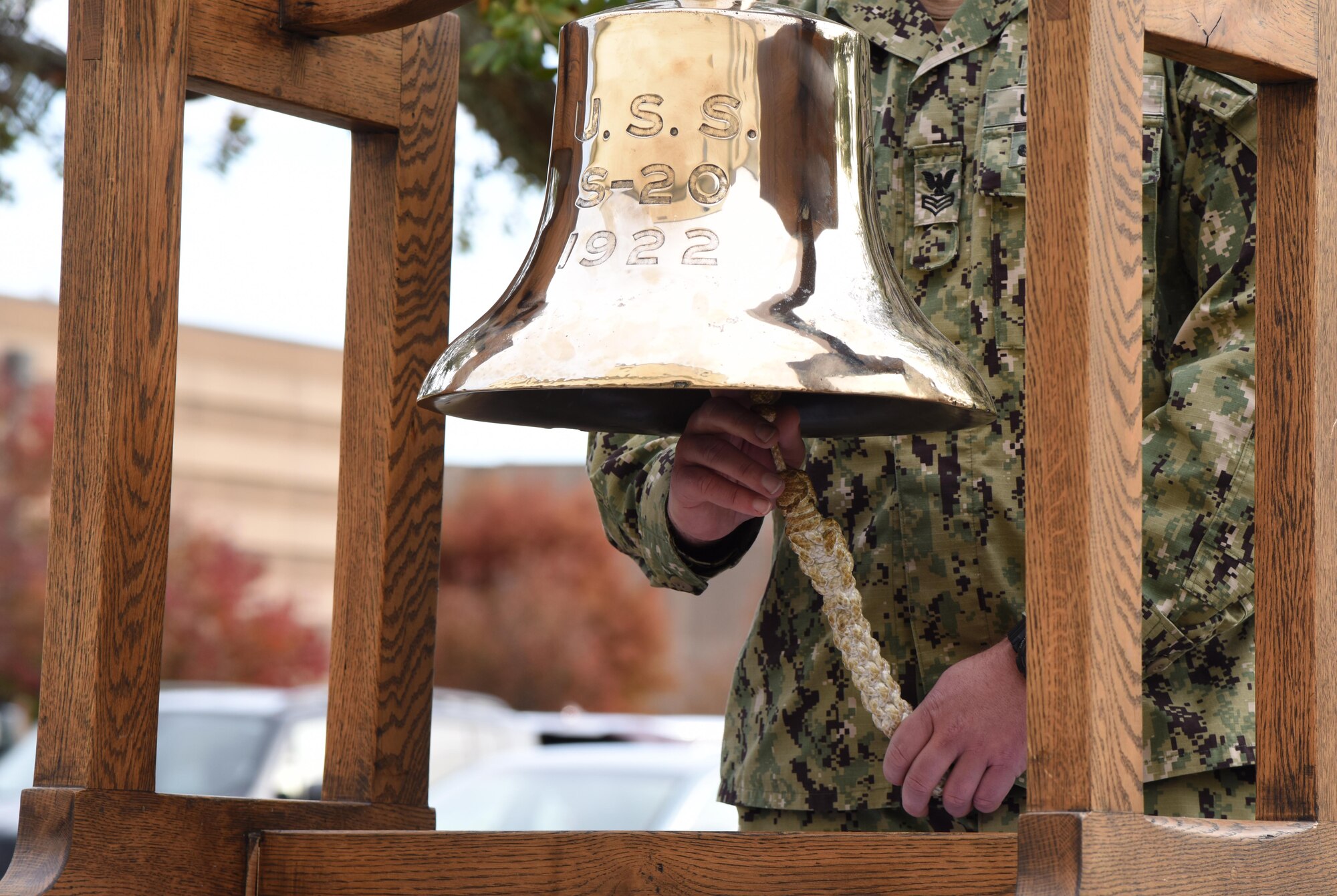 U.S. Navy Aviation Electronics Technician 1st Class Nathaniel Eakins, Center for Naval Aviation Technical Training Unit Keesler instructor, rings a bell during the CNATTU Keesler Pearl Harbor 77th Anniversary Remembrance Ceremony at Keesler Air Force Base, Mississippi, Dec. 7, 2018. The ringing of the bell is done to honor those lost in the Dec. 7, 1941, Pearl Harbor attacks. (U.S. Air Force photo by Kemberly Groue)